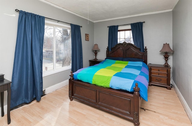 bedroom featuring ornamental molding and light wood-type flooring