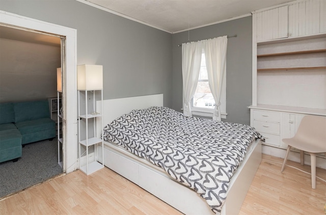 bedroom featuring ornamental molding and light hardwood / wood-style floors