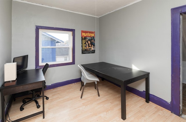 home office with ornamental molding and light hardwood / wood-style flooring