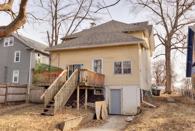 rear view of property featuring a deck