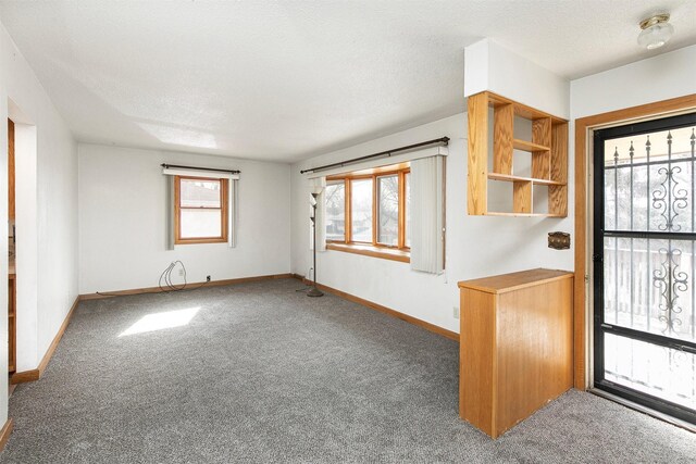 carpeted entrance foyer with a textured ceiling