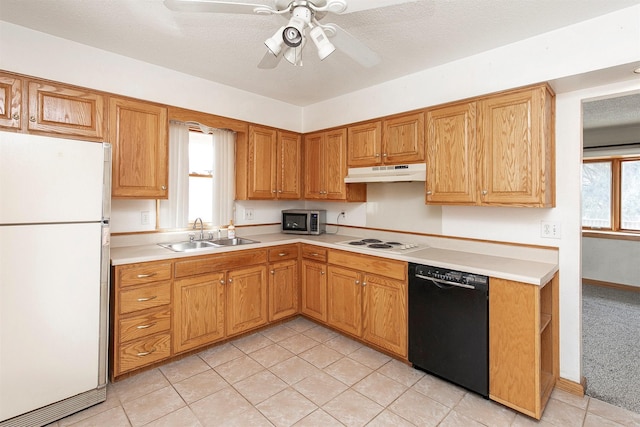 kitchen featuring white appliances, light countertops, a sink, and under cabinet range hood