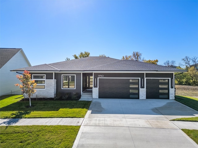 view of front of house featuring a garage and a front lawn