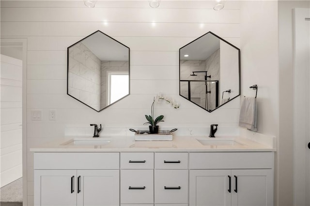 bathroom with vanity and tiled shower