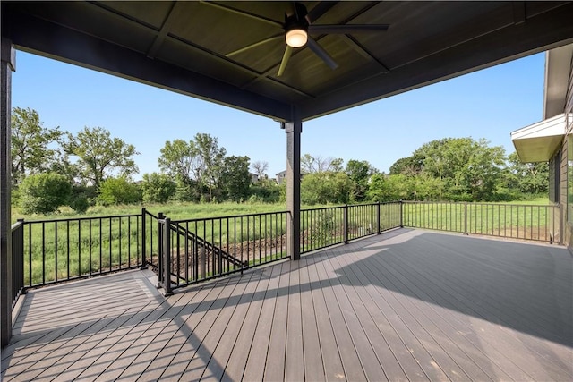 wooden terrace with a yard and ceiling fan