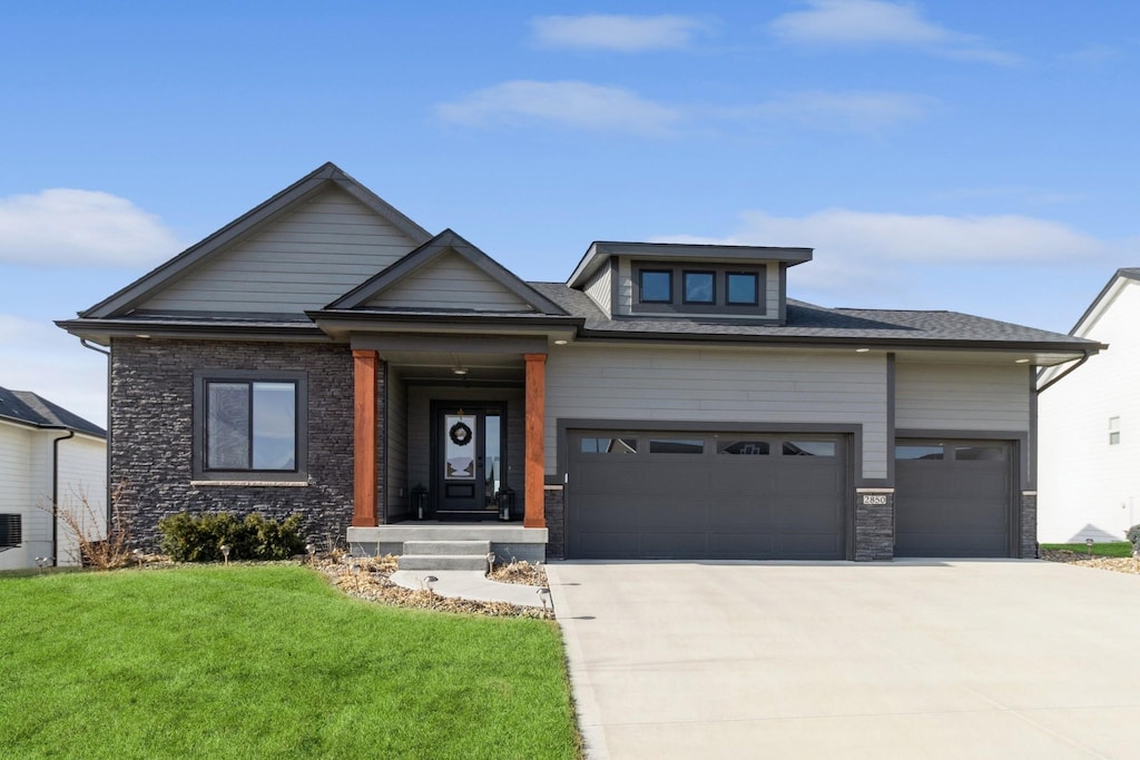 view of front facade with a garage and a front lawn