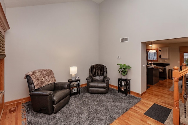 living area with light hardwood / wood-style flooring