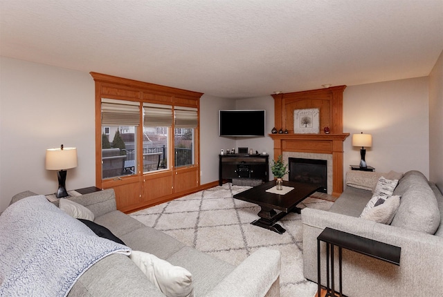 living room featuring a fireplace and a textured ceiling