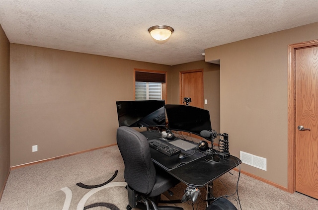 office area with light colored carpet and a textured ceiling