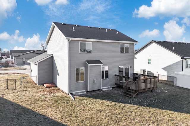 rear view of house featuring central AC unit, a lawn, and a deck