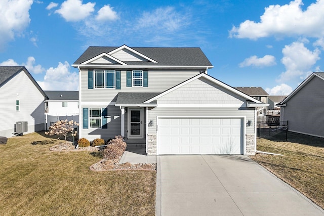 view of front of house with a garage, central AC unit, and a front yard