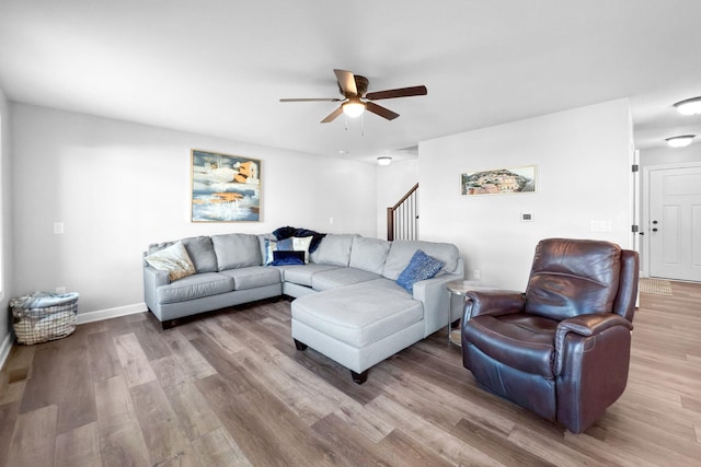 living room featuring ceiling fan and light wood-type flooring