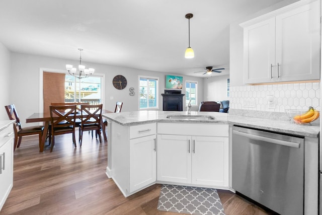 kitchen with stainless steel dishwasher, dark hardwood / wood-style floors, sink, and white cabinets