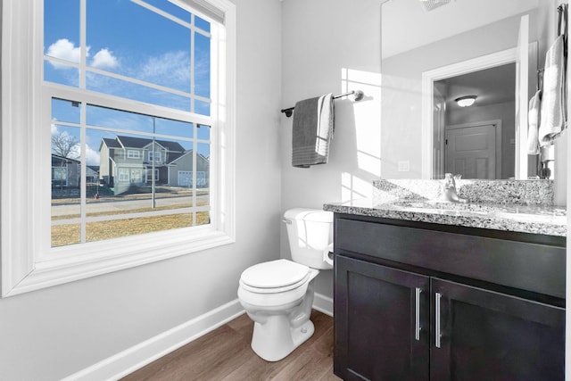 bathroom featuring vanity, hardwood / wood-style floors, and toilet