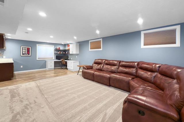 living room with built in desk and light hardwood / wood-style floors