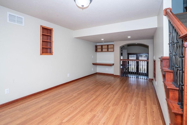 living room featuring light hardwood / wood-style floors and built in features