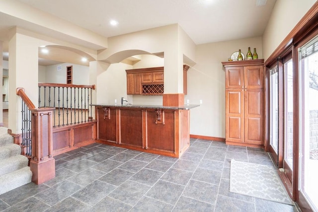 kitchen featuring a breakfast bar and kitchen peninsula