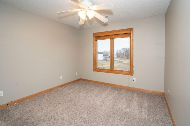 spare room featuring ceiling fan, carpet flooring, and a textured ceiling