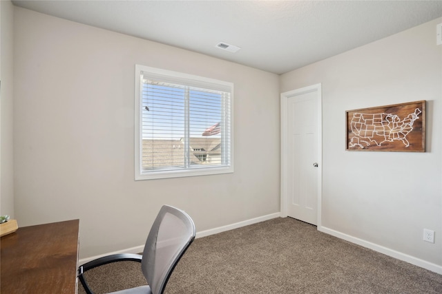 carpeted home office featuring visible vents and baseboards