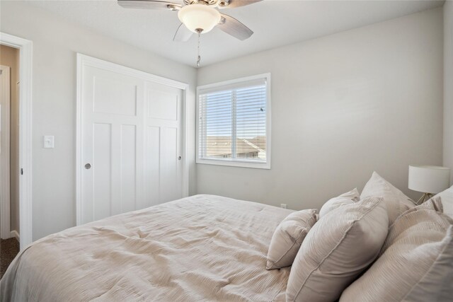 bedroom featuring ceiling fan and a closet