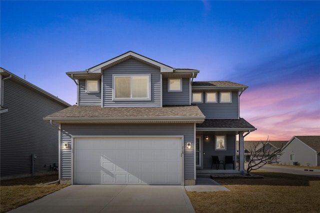 view of front of house featuring concrete driveway, a shingled roof, and an attached garage