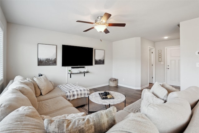 living room with ceiling fan, baseboards, and dark wood-style flooring