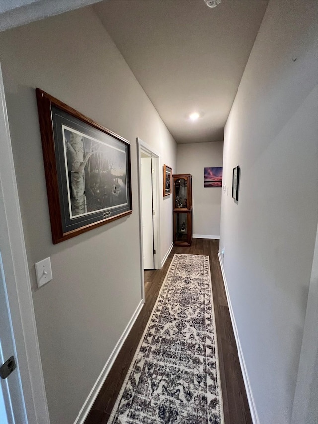 hall with dark wood-type flooring