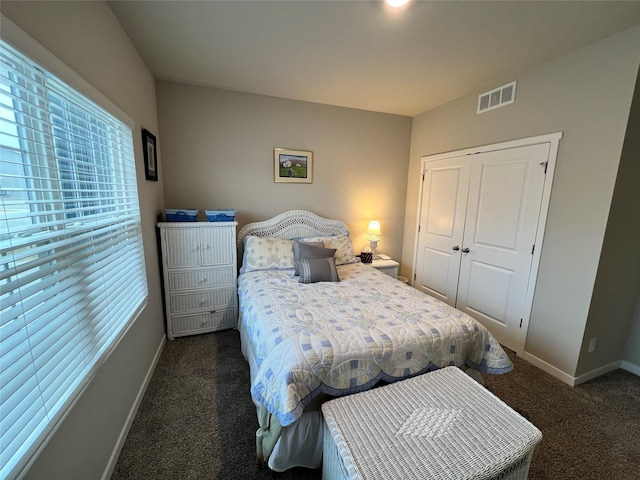 bedroom featuring dark carpet and a closet