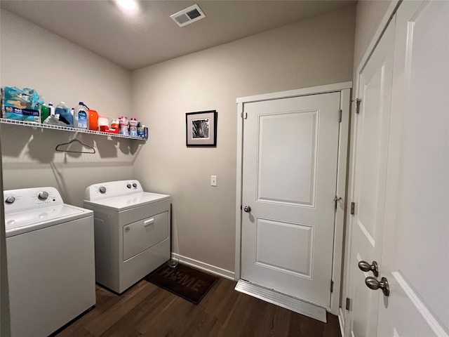 clothes washing area featuring dark hardwood / wood-style flooring and washing machine and dryer