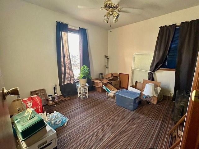 interior space featuring ceiling fan and carpet