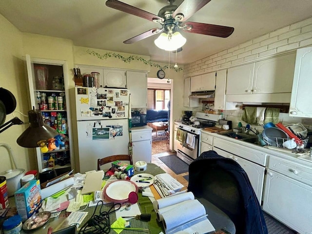 kitchen featuring sink, white appliances, ceiling fan, and brick wall