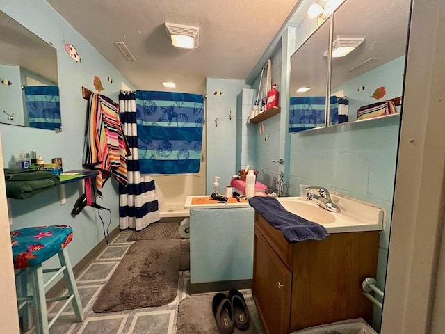 bathroom featuring vanity and a shower with shower curtain