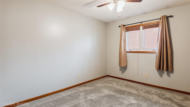 carpeted spare room with ceiling fan