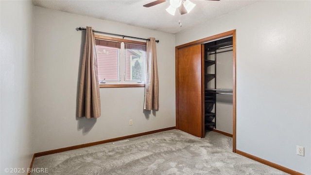 unfurnished bedroom featuring light colored carpet, ceiling fan, and a closet