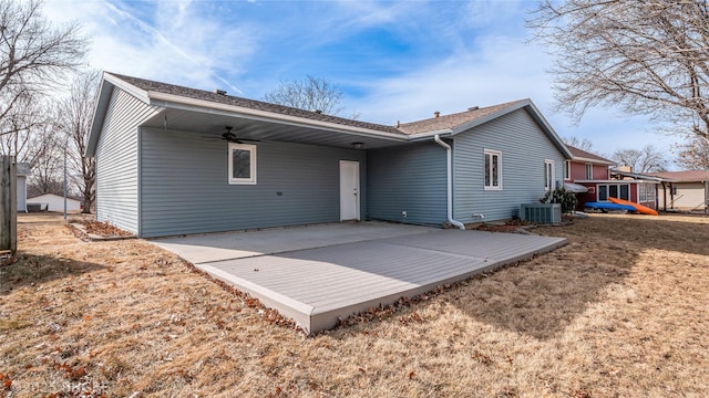 rear view of house featuring central AC, a patio, ceiling fan, and a lawn