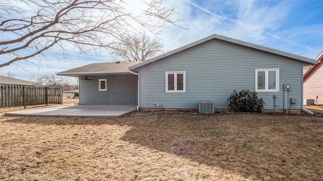 back of house featuring central AC, a patio, and a lawn