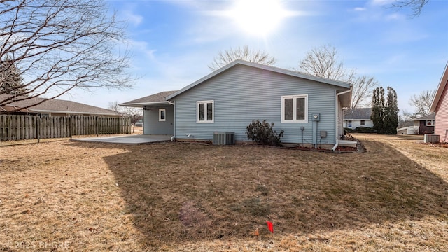 back of property featuring a lawn, a patio, and central air condition unit