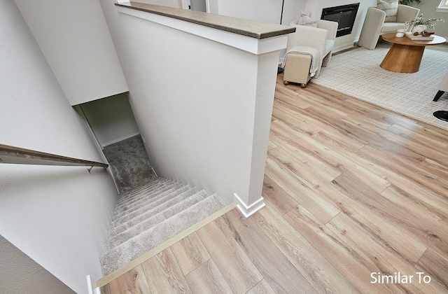 stairs with hardwood / wood-style flooring