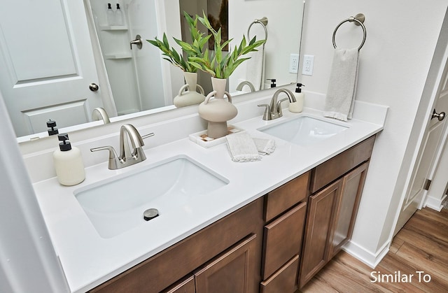 bathroom featuring hardwood / wood-style flooring and vanity