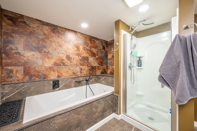 bathroom with independent shower and bath and tile walls