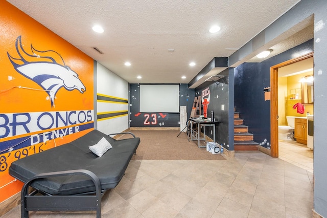 home theater room featuring a textured ceiling