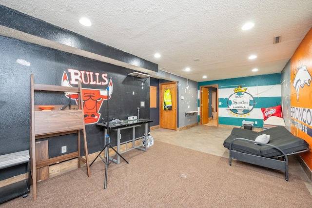 playroom with carpet flooring and a textured ceiling