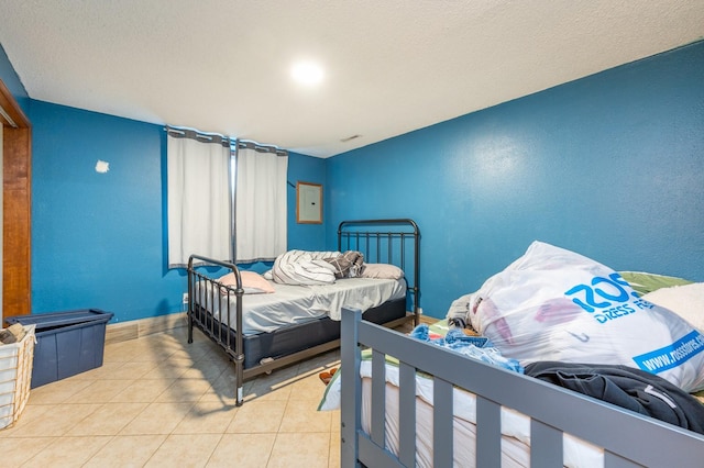 bedroom featuring light tile patterned floors