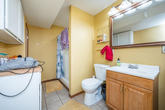 bathroom with vanity, tile patterned flooring, toilet, and walk in shower