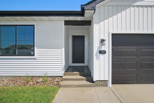 1927 Tuscany Dr SE, Altoona, IA 50009 - doorway to property featuring board and batten siding and a garage