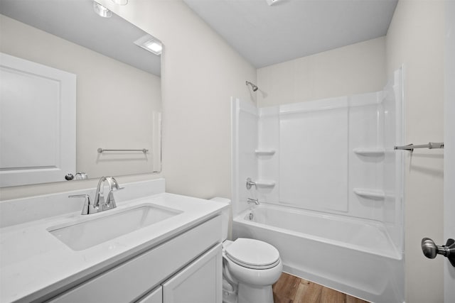 full bathroom with vanity, hardwood / wood-style flooring, bathing tub / shower combination, and toilet