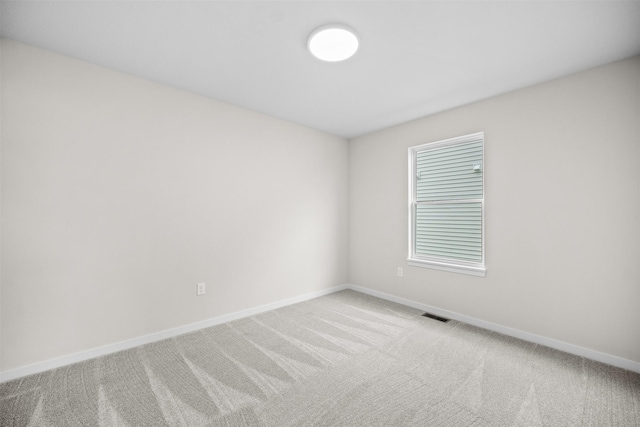 unfurnished room with light carpet