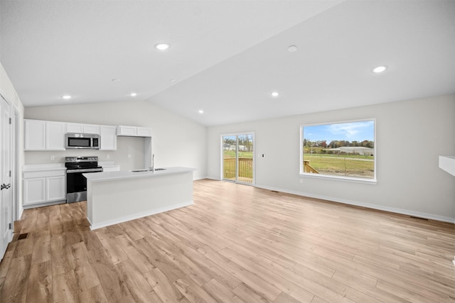 kitchen featuring sink, light hardwood / wood-style flooring, appliances with stainless steel finishes, an island with sink, and white cabinets