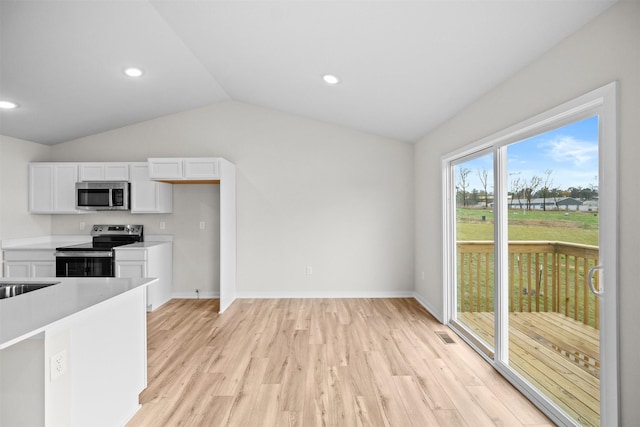 kitchen with white cabinetry, light hardwood / wood-style flooring, vaulted ceiling, and appliances with stainless steel finishes