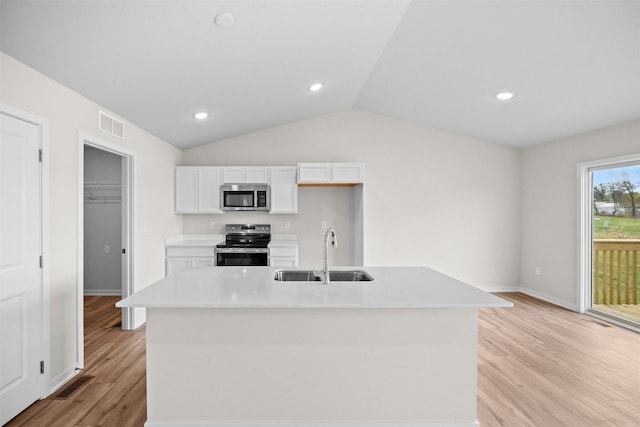 kitchen featuring sink, white cabinetry, appliances with stainless steel finishes, an island with sink, and light hardwood / wood-style floors